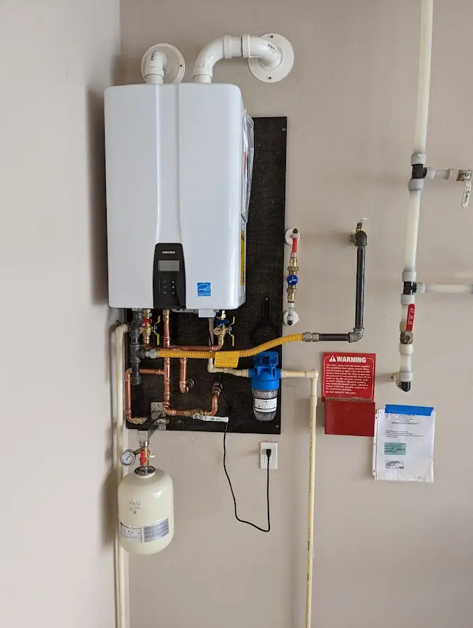 Professional plumber installing copper piping in a Toppenish home